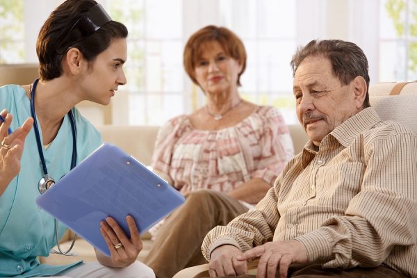 Nurse talking with elderly paitents